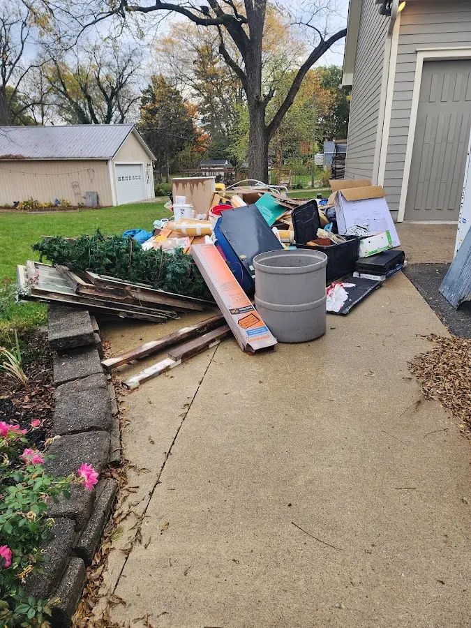 Dumpster being loaded with debris for Estate Cleanout Dumpster Rental in Greensburg
